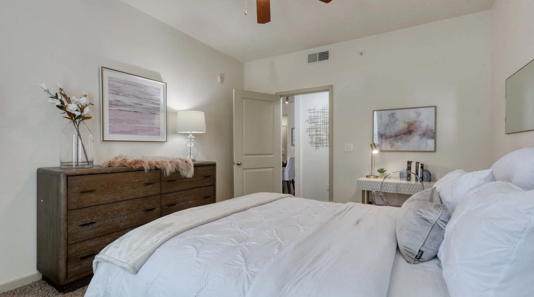 a bedroom with a bed and a dresser